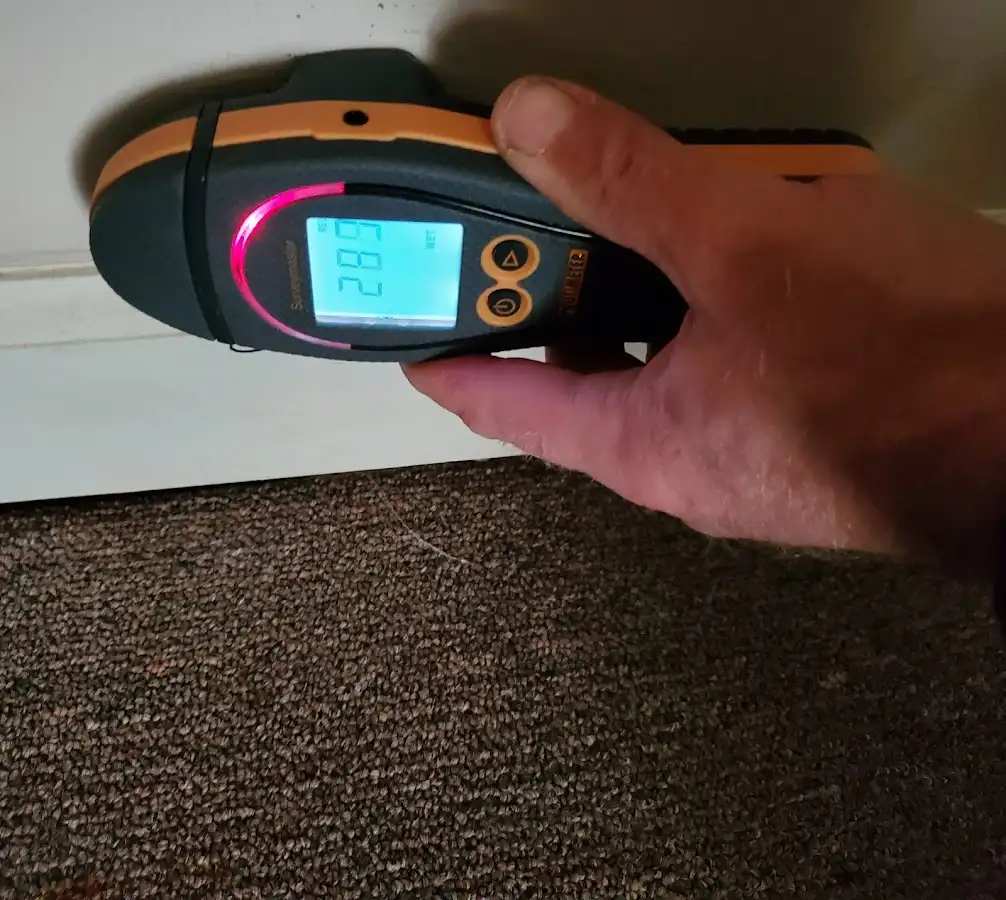 Moisture detection at baseboard during Storm Damage Restoration in St. John